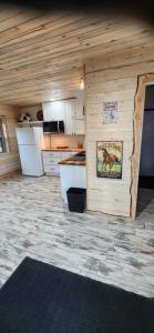 a kitchen with a wooden wall in a house at Rustic Treehouse in Peyton