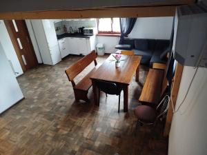 a living room with a wooden table and a couch at Domek przy Złotym Groniu in Istebna