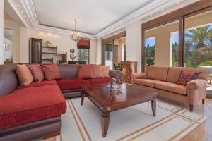 een woonkamer met banken en een salontafel bij Coral Tree Luxury Villa in Ialyssos +25 foto's