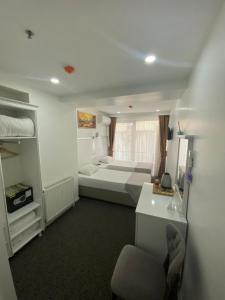 a room with two beds and a desk in it at Beyhan Hotel in Istanbul