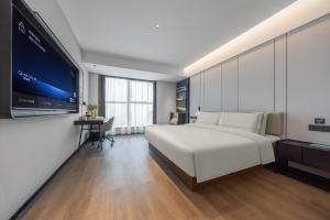 Ένα ή περισσότερα κρεβάτια σε δωμάτιο στο Atour Hotel Kunming Guandu Longhu Times Financial Center