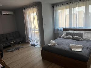 a bedroom with a bed with two towels on it at Piemona Mini Apartman in Miskolc