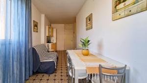 a dining room with a table and chairs in a room at Condominio Carina Sud in Bibione