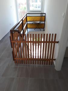 a set of three wooden stairs in a room at Napsugár apartman Balatonboglár in Balatonboglár
