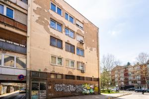 a building with graffiti on the side of it at Modern 1 BDR with Balcony in Sarajevo