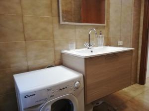 a bathroom with a washing machine and a sink at Costa degli Etruschi terrazza vista mare in Piombino +22 photos