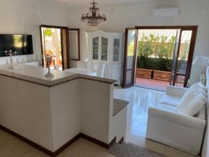 a kitchen with a counter and a living room at Costa degli Etruschi terrazza vista mare in Piombino