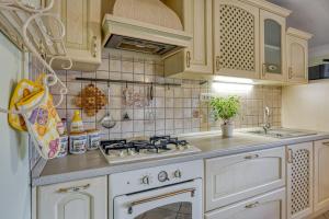 a kitchen with a white stove and a sink at Apartment Marta Slovenia Natures - Happy Rentals in Levpa