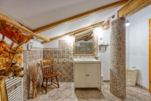 a bathroom with a sink and a chair at Apartment Marta Slovenia Natures - Happy Rentals in Levpa