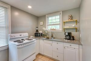 Una cocina blanca con estufa y fregadero. en 2 Mi to Dtwn Pensacola Charming Apartment, en Pensacola