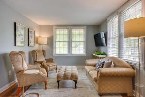 Una sala de estar con un sofá y sillas y ventanas. en 2 Mi to Dtwn Pensacola Charming Apartment, en Pensacola