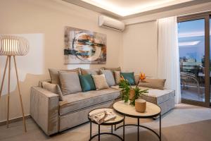 a living room with a couch and a table at Theatro Living in Elegance - Luxury Apartments in Hersonissos in Hersonissos