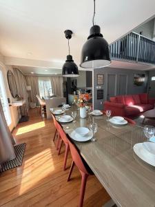 a dining room and living room with a long table at Pocono Chalet,Hot Tub,Arcade,Fireplace, Lake,Pool, Pet friendly, near Jim Thorpe No extra fees to use amenities in Towamensing Trails