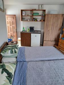 a small bedroom with a bed and a kitchen at Terrace Studio in Rhodes Town
