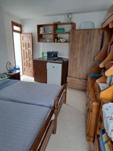 a bedroom with a bed and a kitchen with a stove at Terrace Studio in Rhodes Town