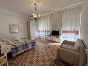 a bedroom with a bed and a couch at Casa sulla Piazzetta in Olbia +2 photos