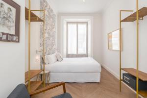 A bed or beds in a room at Be Mate Málaga Centro