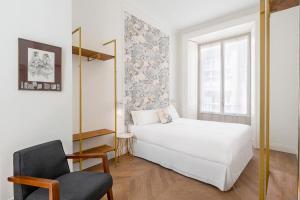 A bed or beds in a room at Be Mate Málaga Centro