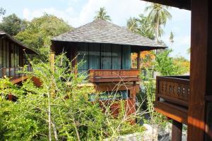 a resort building with a balcony and trees at Avatar Railay in Railay Beach