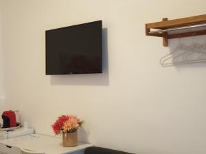 a flat screen tv hanging on a white wall at Cartia Affittacamere in Ragusa