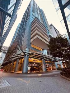 a tall building with a store in front of it at Summer Hotel and Condo Suites Nearby KLCC Area in Kuala Lumpur