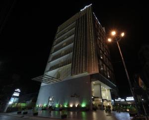 a tall building at night with a street light at Royal Casa Cochin in Cochin