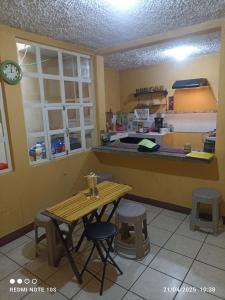 a kitchen with a counter and a table and a counter top at Apartamento Luna Bella in Chitay