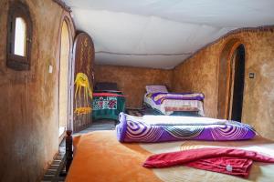 a room with three beds in a room with at Sky Luxury Camp in Mhamid