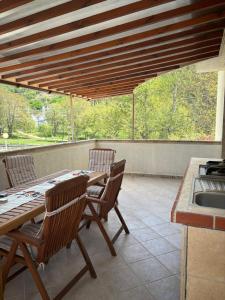 a patio with a table and chairs and a sink at Luxury Park Villa in Sandanski