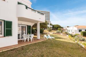 a patio with a table and chairs on a lawn at Apartamento Els Pins by Escapehome in Punta Grossa