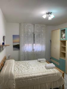a bedroom with a large bed and a window at Casa Ligorio in San Michele Salentino