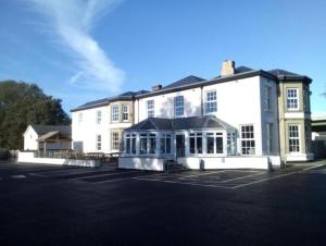 a large white building with a lot of windows at Coach House 2 in St Asaph