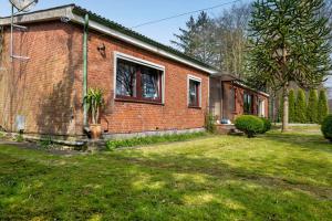 a brick house with a window in a yard at Ferienwohnung Alberto in Drelsdorf