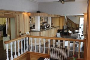 a room with a staircase and a living room and a kitchen at Coach House 2 in St Asaph