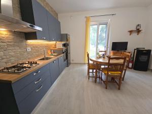 a kitchen with blue cabinets and a table with a dining room at Casa vacanze Le cicale in Pesaro
