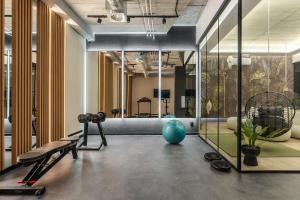 a gym with a treadmill and a blue ball in a room at Reset in Muse Spa Collection in Krakow
