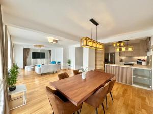 a kitchen and living room with a wooden table and chairs at Luxury Apartments Przno in Budva