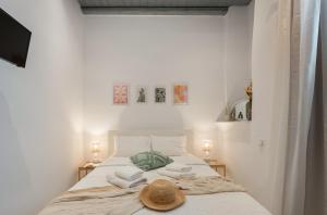 a bedroom with a bed with towels and a hat on it at Caper-2 Bedroom traditional home with amazing view in Naousa