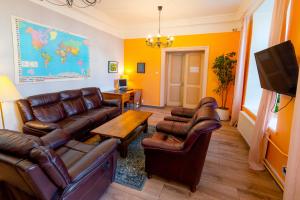 a living room with leather furniture and a tv at 16eur - Old Town Munkenhof in Tallinn