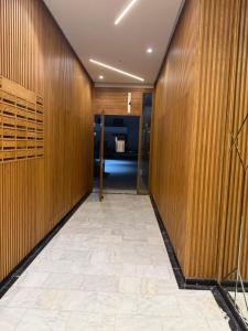 a hallway with wooden walls and a tile floor at Appartement a zenata ain-harrouda casablanca in Mohammedia