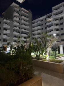 a view of two large buildings at night at Appartement a zenata ain-harrouda casablanca in Mohammedia