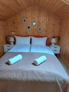 a bedroom with a bed with two pillows on it at Landhaus Camelia in Otavice