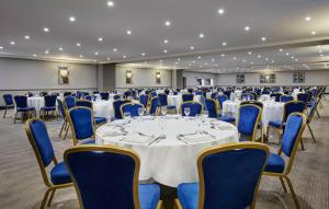 a room with a table and chairs in a room at Leonardo Hotel and Conference Venue Hinckley Island - Formerly Jurys Inn in Hinckley