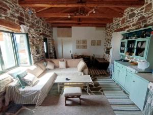 a living room with a couch and a table at Moonstone retreat in Mesokhória