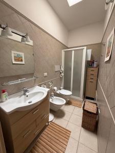 a bathroom with a sink and a toilet at Marina di Ostuni - Private Villa 400 meters from the sea in Ostuni Costa Merlata