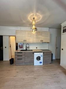 a kitchen with a washing machine in the middle at Beautiful 3-room, Porte Saint-Cloud, Paris in Paris