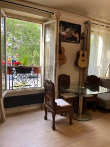 a living room with a glass table and a window at Beautiful 3-room, Porte Saint-Cloud, Paris in Paris