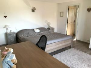 a bedroom with a bed and a table with a teddy bear at Jardin d’Uzès - Climatisée avec piscine in Saint-Quentin-la-Poterie +12 photos