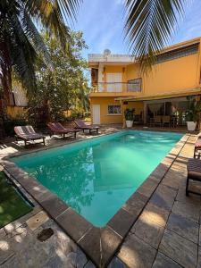 a swimming pool in front of a house at Villa Arcadia in Nosy Be