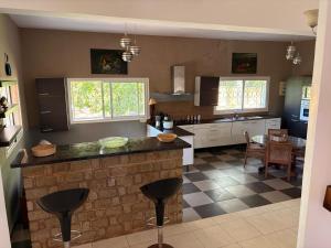 a kitchen with a island in the middle of a room at Villa Arcadia in Nosy Be